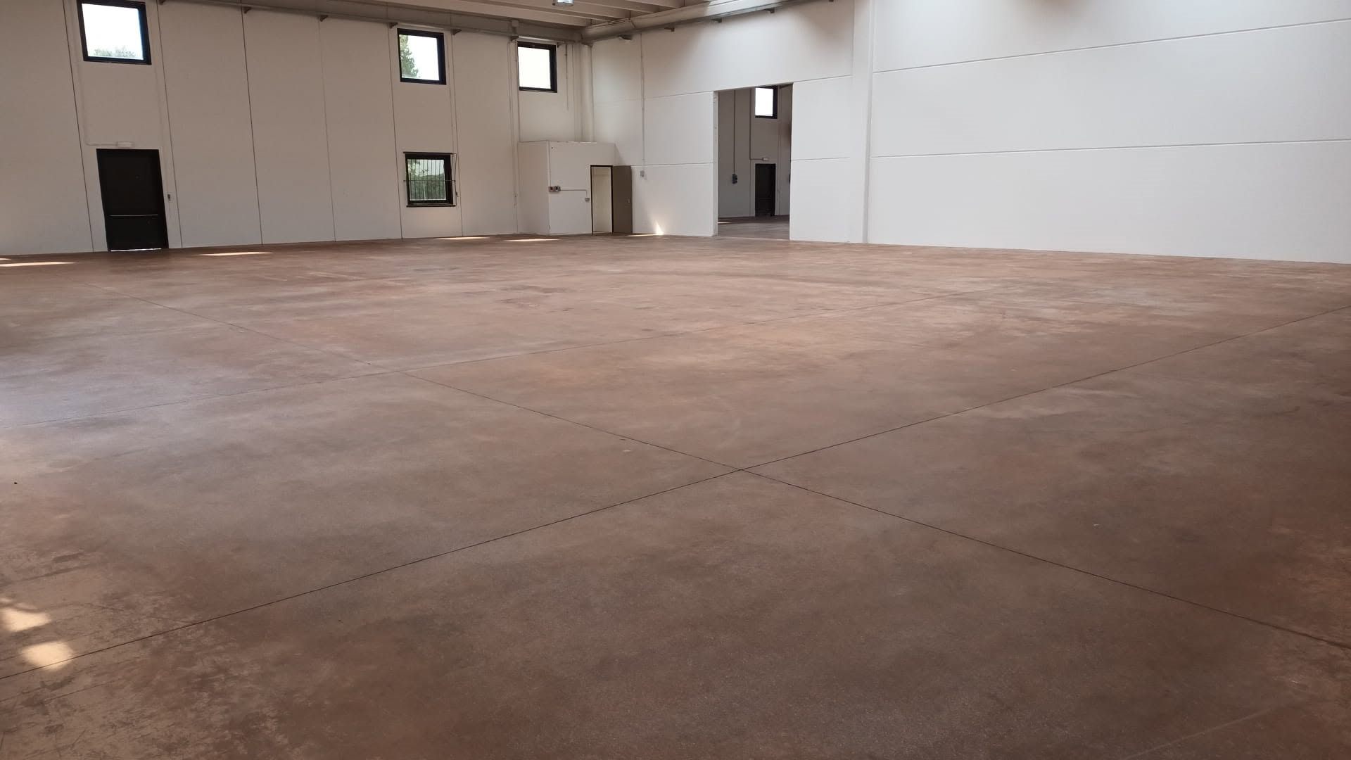 Capannone industriale vuoto con pavimento in cemento appena pulito