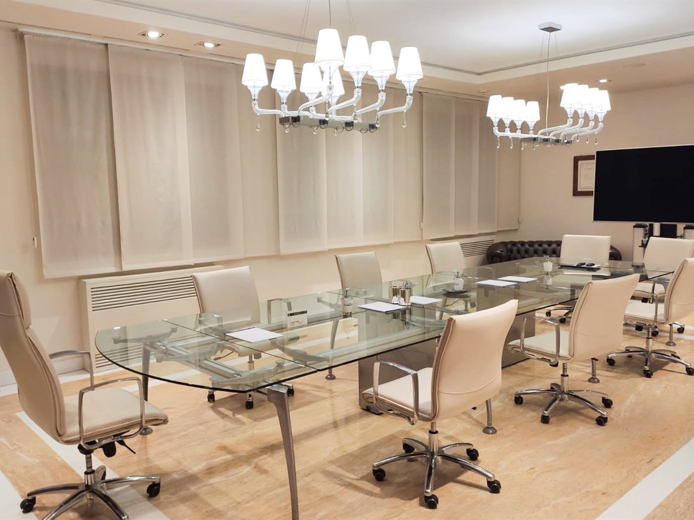 Sala riunioni con tavolo in cristallo e pavimento in marmo
